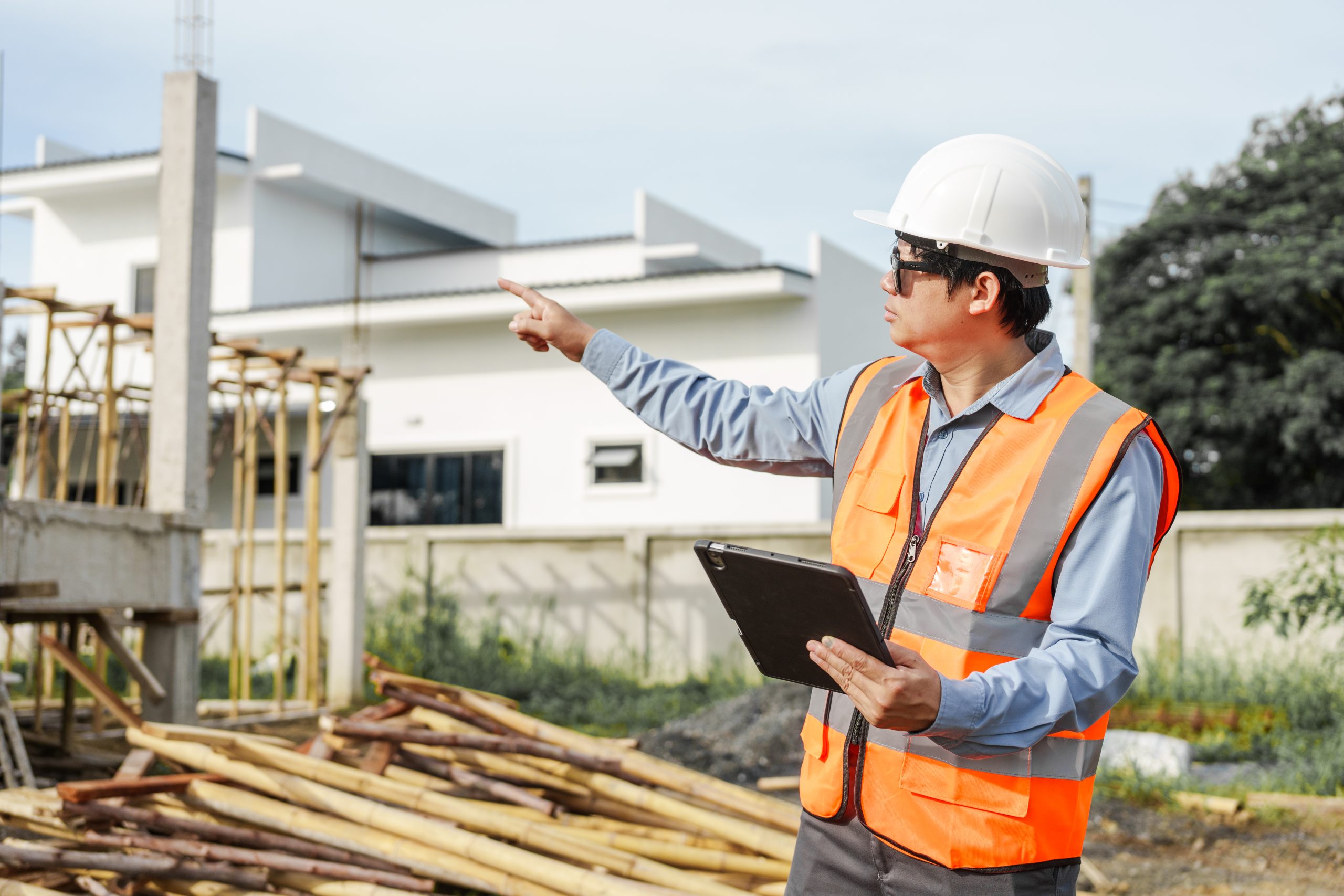 Asian builder point to an area that needs a decision made.