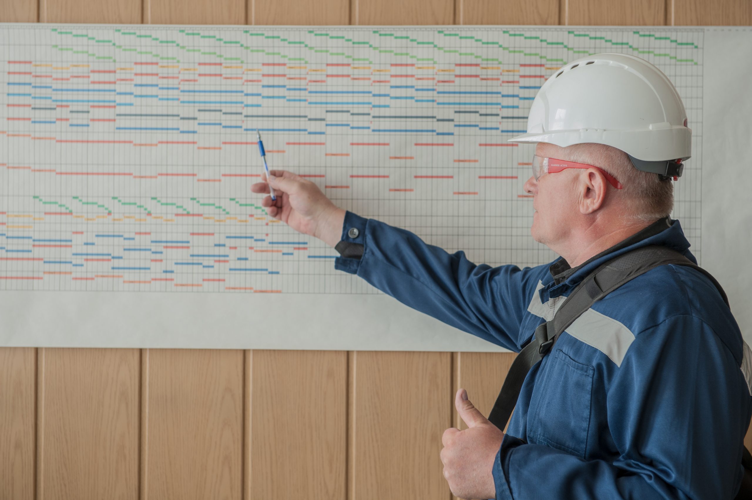 image of builder looking at a schedule on the wall